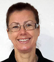 Emma Gregory, personal trainer, smiling in a black zip top